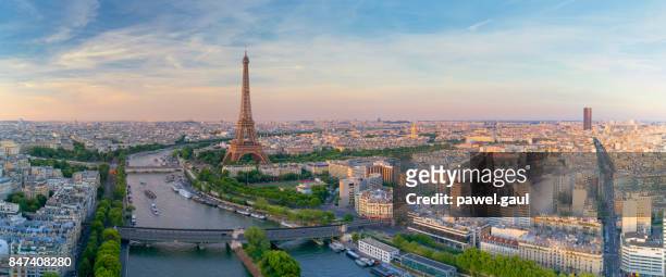aerial view of paris with eiffel tower during sunset - panoramic stock pictures, royalty-free photos & images