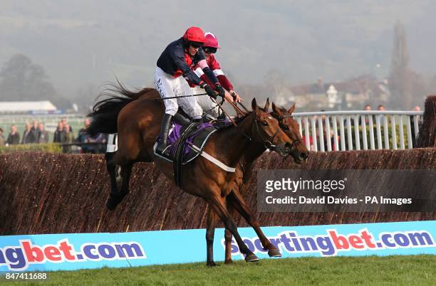 Bobs Worth ridden by Barry Geraghty clears a fence ahead of First Lieutenant ridden by Davy Russell on the way to winning the RSA Chase on Ladies...