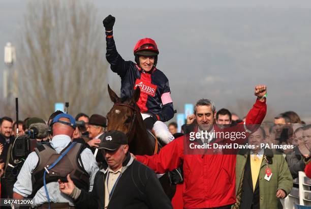 Jockey Barry Geraghty celebrates after winning the RSA Chase on Bobs Worth during Ladies Day, at the Cheltenham Festival.