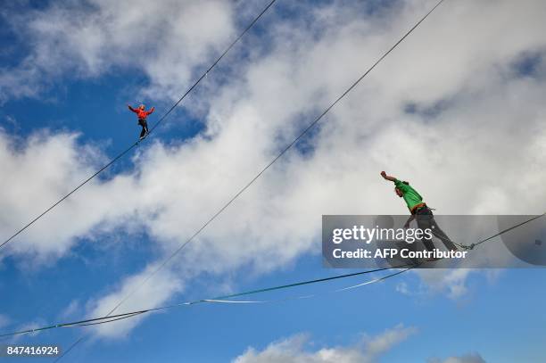 Samuel Volery of Switzerland and Tijmen Van Dieren of Netherlands walk on lines during the Highline Extreme event in Moleson peak, western...