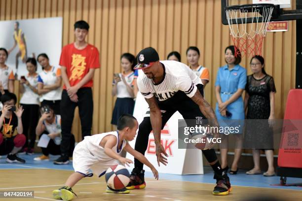 Player George Hill of the Sacramento Kings plays basketball with children at a kindergarten on September 15, 2017 in Guangzhou, China.