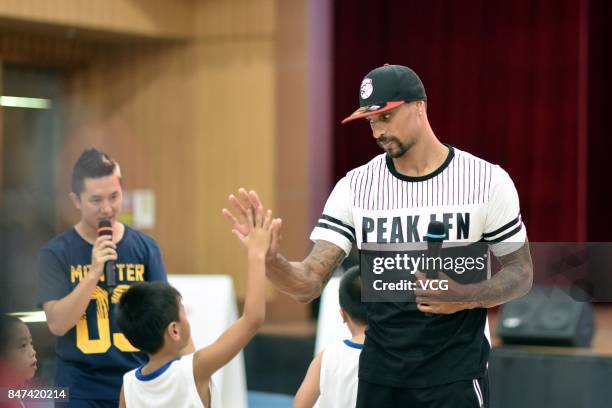 Player George Hill of the Sacramento Kings plays basketball with children at a kindergarten on September 15, 2017 in Guangzhou, China.