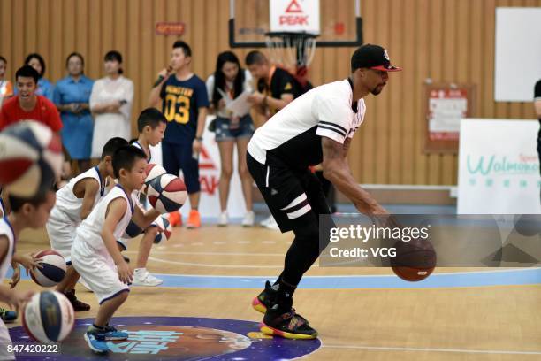 Player George Hill of the Sacramento Kings plays basketball with children at a kindergarten on September 15, 2017 in Guangzhou, China.