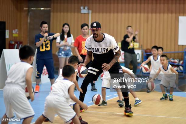 Player George Hill of the Sacramento Kings plays basketball with children at a kindergarten on September 15, 2017 in Guangzhou, China.