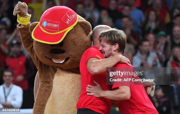 Belgium's David Goffin celebrates with Belgium's captain Johan Van Herck after winning against Australia's John Millman in their singles rubber for...