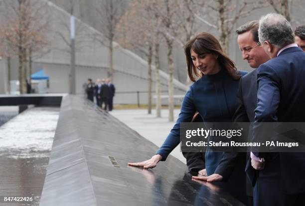 Prime Minister David Cameron and his wife Samantha touch a memorial to 9/11 victims where British citizen Katherine Wolf is remembered, at the Ground...