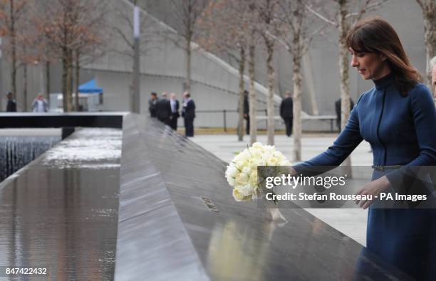 Samantha Cameron, wife of the British Prime Minister, lays flowers on the name of Katherine Wolf, a British citizen who died on 9/11 at the memorial...