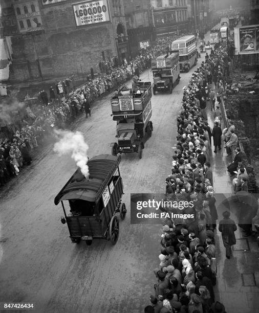 An old steam wagon puffs down Ludgate Hill followed by period motor buses from London Transport in the Lord mayor's procession to the Royal Courts of...