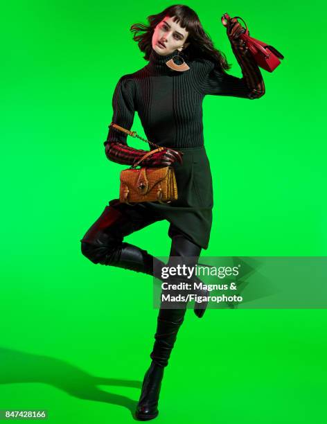 Model Sibui poses at a fashion shoot for Madame Figaro on July 8, 2017 in Paris, France. Sweater, pants and City Knot bag , earring , Bianco bag ,...