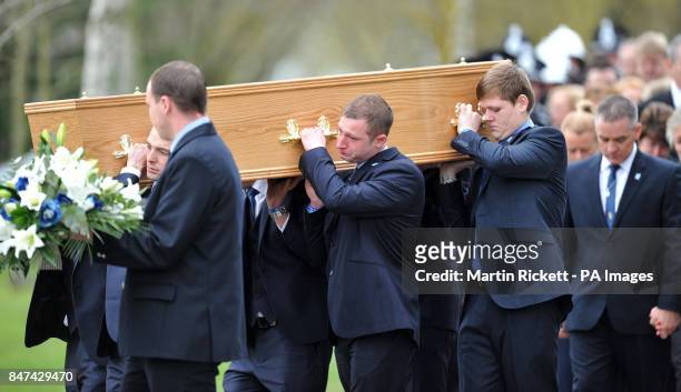The coffin of Pc David Rathband is carried from Stafford Crematorium at his funeral as his twin brother Darren follows.