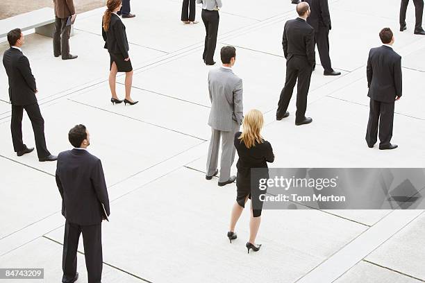 businesspeople standing in office building courtyard - following bildbanksfoton och bilder