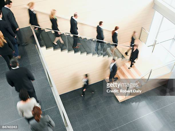 uomini d'affari a piedi in ufficio scala - partire foto e immagini stock