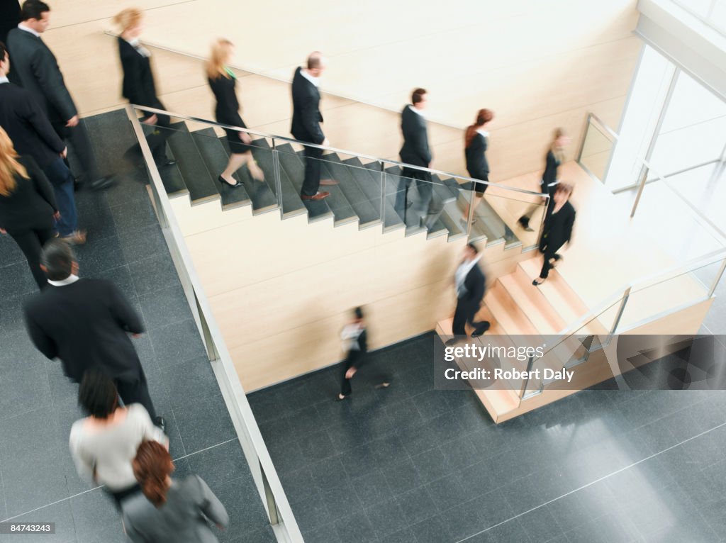 Businesspeople walking down office staircase