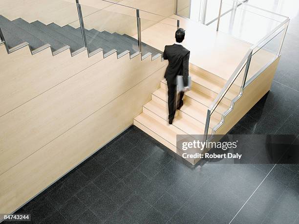 businessman ascending office stairs - de volgende stap stockfoto's en -beelden