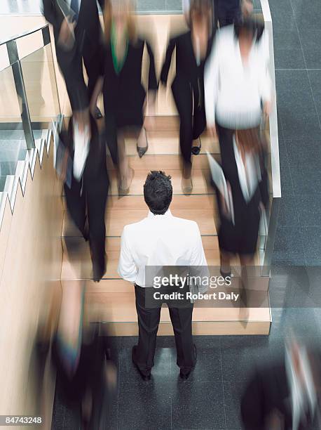 businessman looking up busy office staircase - a separate peace stock pictures, royalty-free photos & images