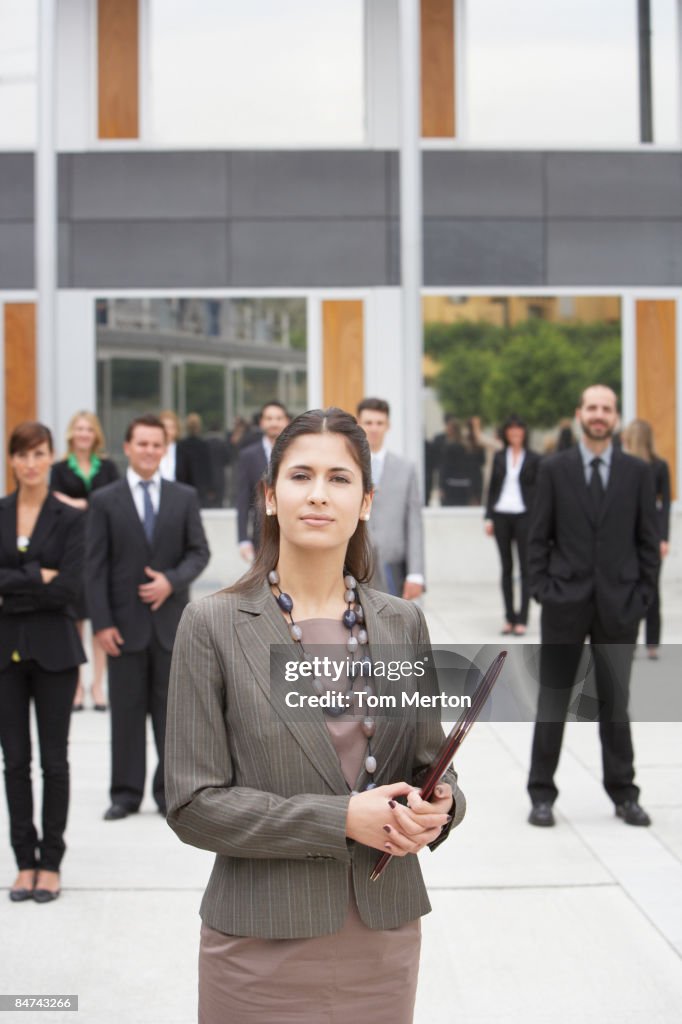 Businesspeople standing in office building courtyard