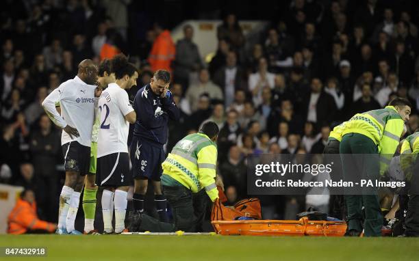 The medical team tend to Bolton Wanderers' Fabrice Muamba as manager Owen Coyle and Tottenham Hotspur's Benoit Assou-Ekotto and William Gallas look on