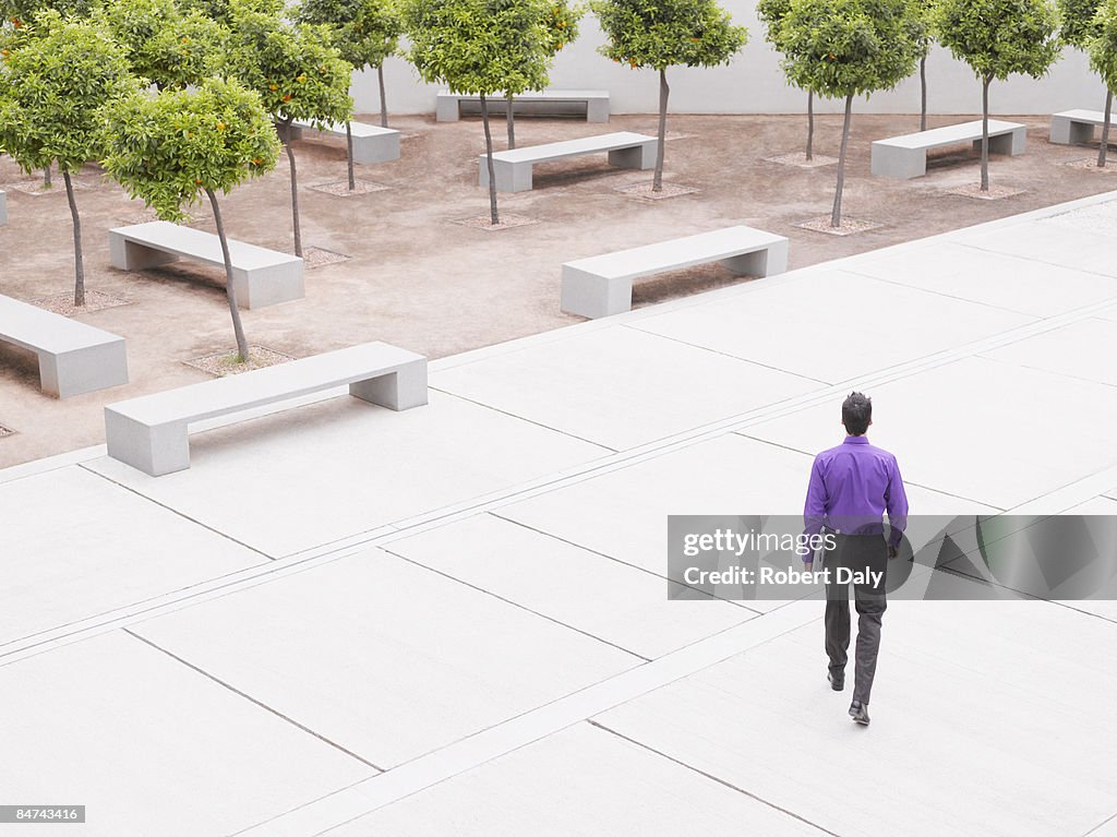 Businessman walking in modern courtyard