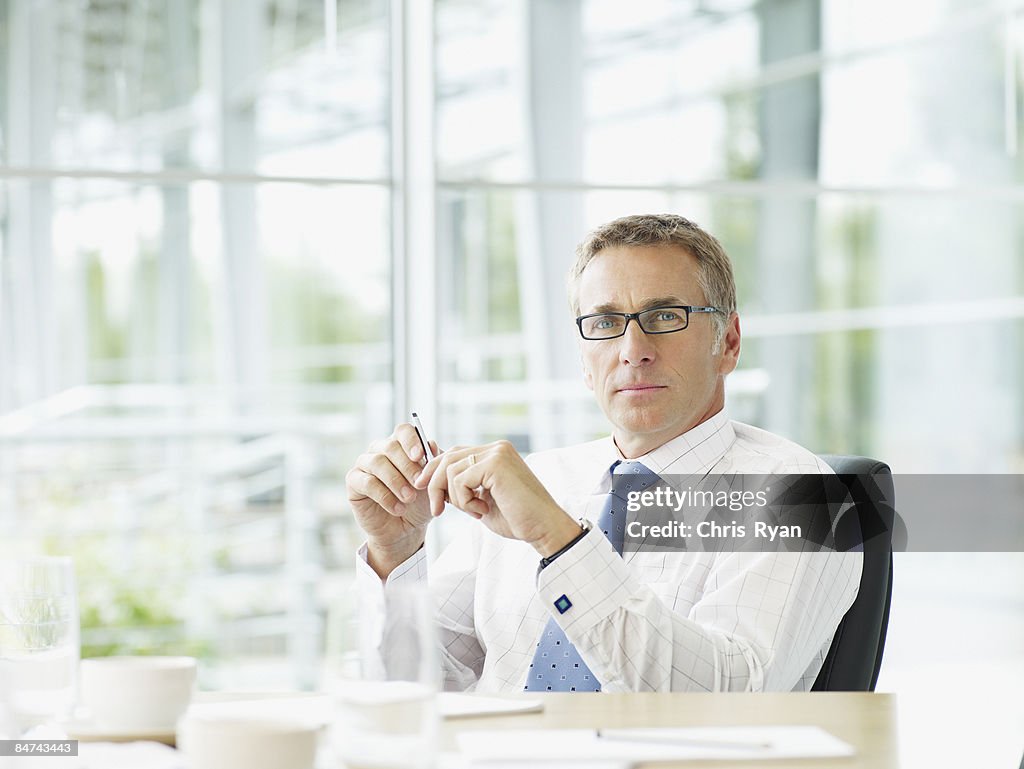 Businessman sitting at conference table