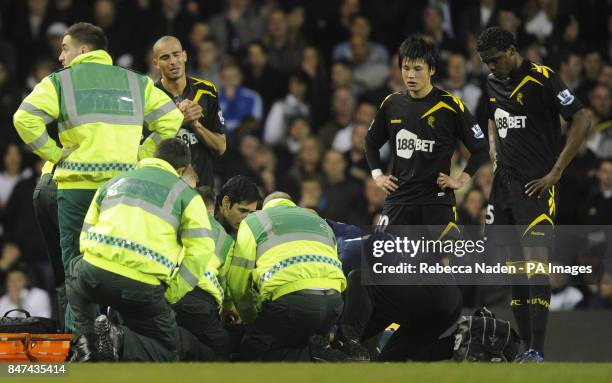 The medical team tend to Bolton Wanderers' Fabrice Muamba as Ryo Miyaichi, Darren Pratley and Dedryck Boyata look on during the FA Cup Sixth Round...