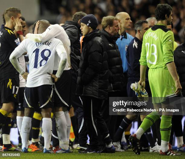 Tottenham Hotspur's Jermain Defoe is consoled as Bolton Wanderers' Fabrice Muamba is stretchered off during the FA Cup Sixth Round match at White...