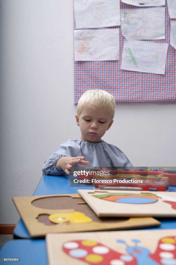 Boy playing with toys in school