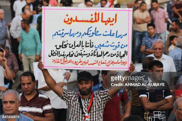 Iraqi followers of cleric Moqtada al-Sadr take part in a demonstration against corruption in Iraq and demanding reform and a change in the electoral...