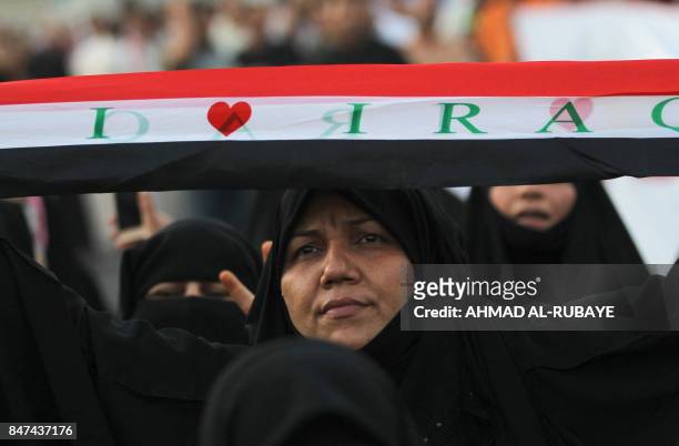 An Iraqi woman, a follower of cleric Moqtada al-Sadr, takes part in a demonstration against corruption in Iraq and demanding reform and a change in...