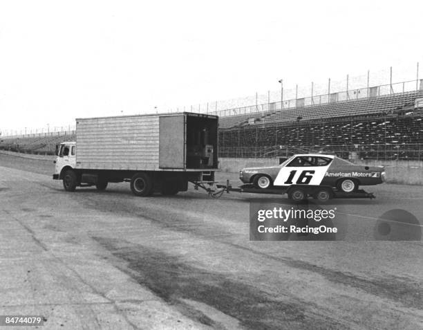 The Roger Penske AMC Matador heading for the Daytona garage area from the track crossover gate. The driver was Mark Donohue, and the tow rig was a...