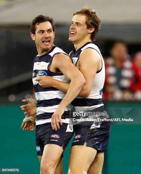 Daniel Menzel of the Cats celebrates a goal with Jake Kolodjashnij of the Cats during the 2017 AFL Second Semi Final match between the Geelong Cats...