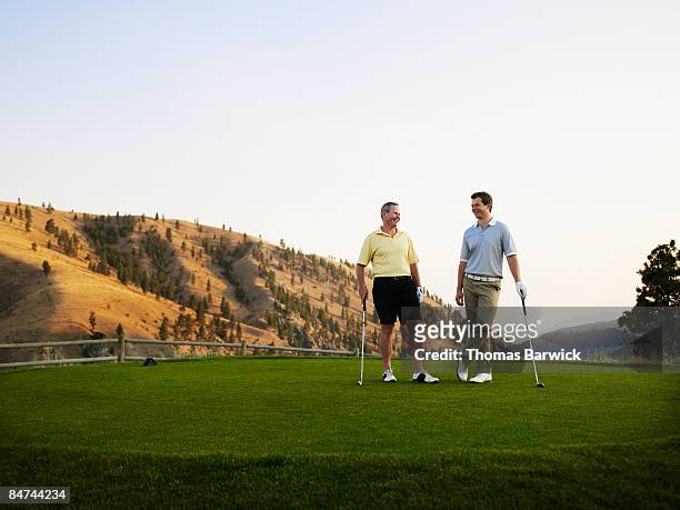 father and son on golf course, laughing - father son golf stock pictures, royalty-free photos & images