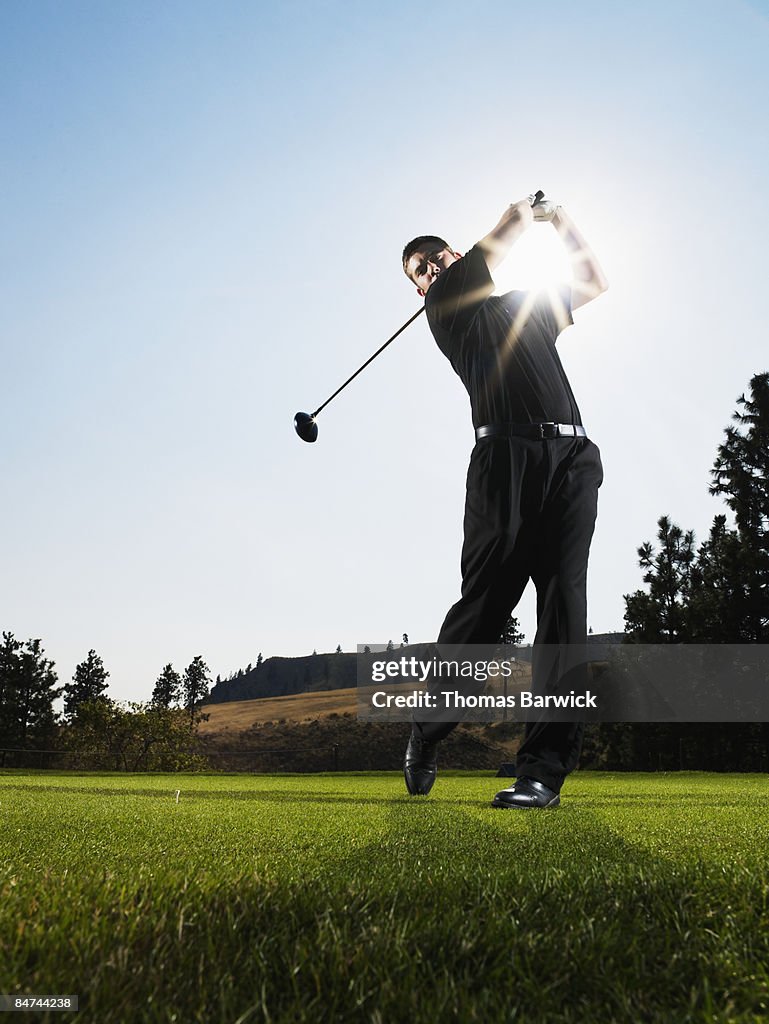 Male golfer hitting tee shot