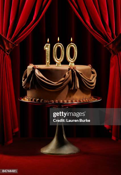 birthday cake on stage with 100 candles - 100 birthday stock pictures, royalty-free photos & images