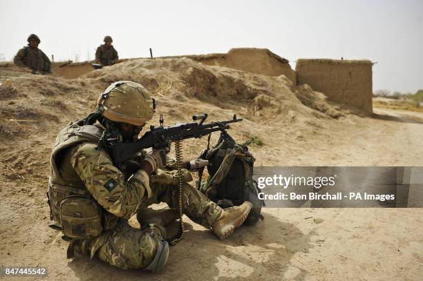 Lance Corporal Nico Bolatagn of 3 Yorks, who lost men in an IED blast on their Warrior armoured vehicle, points his General Purpose Machine Gun down...