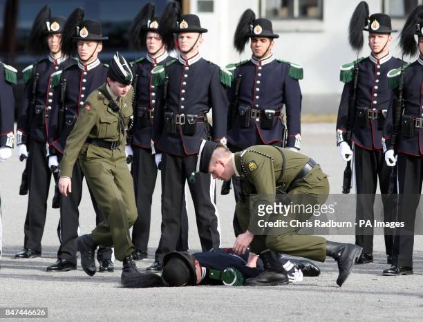Serviceman from the Guard of Honor faints before the arrival of The Prince of Wales and The Duchess of Cornwall, at a wreath laying ceremony at the...