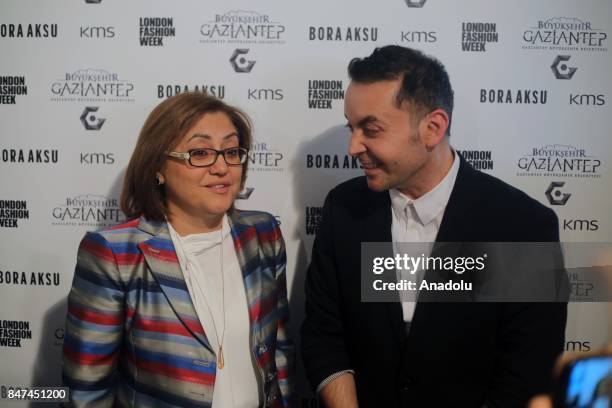 Turkish Fashion Designer Bora Aksu and Major of Gaziantep Fatma Sahin pose for a photo after Aksu's show, which presents Gaziantep's traditional...