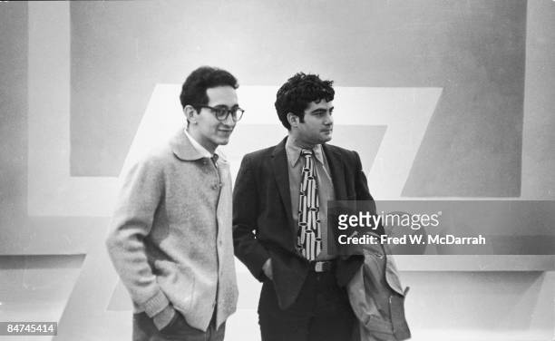 American artists Frank Stella and Larry Poons attend an exhibit of Stella's work at the Castelli Gallery, New York, New York, March 5, 1966.