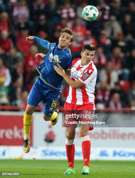 Christoffer Nyman of Braunschweig and Fabian Schoenheim of Berlin jump for a header during the Second Bundesliga match between 1. FC Union Berlin and...