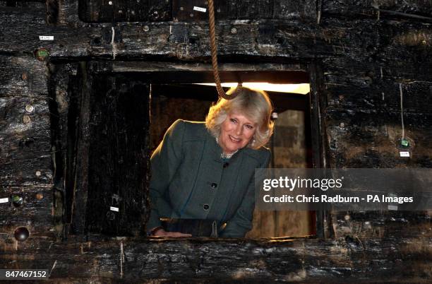 The Duchess of Cornwall peers through a gun turret, during a visit to the warrior ship Vasa, the world's last surviving 17th century ship, housed in...