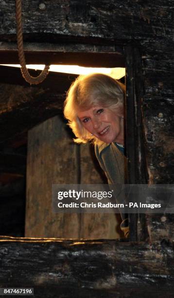 The Duchess of Cornwall peers through a gun turret, during a visit to the warrior ship Vasa, the world's last surviving 17th century ship, housed in...