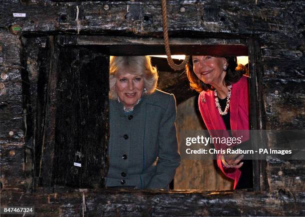 The Duchess of Cornwall and Queen Silvia of Sweden, peer through a gun turret, during a visit to the warrior ship Vasa, the world's last surviving...