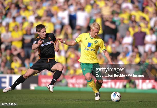 Norwich City's Zak Whitbread is challenged by Wolverhampton Wanderers' Kevin Doyle during the Barclays Premier League match at Carrow Road, Norwich.