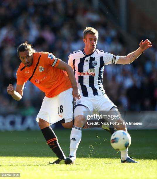 West Bromwich Albion's Chris Brunt and Newcastle United's Jonas Gutierrez battle for the ball