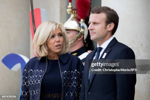 French President Emmanuel Macron and his wife Brigitte Trogneux wait to welcome their guests to celebrate Paris being announced as the host of the...