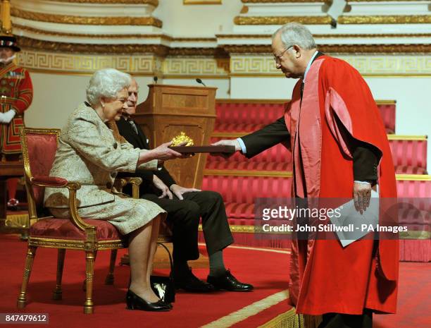 Queen Elizabeth II accompanied by the Duke of Edinburgh receives a copy of the loyal address from the Chancellor of Cambridge university Lord...
