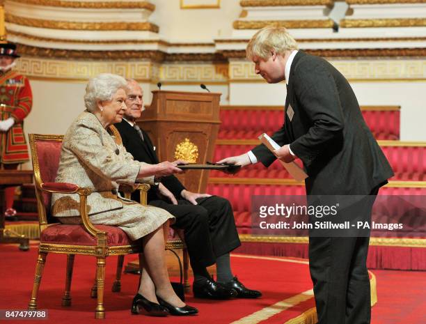 Queen Elizabeth II accompanied by the Duke of Edinburgh receives a copy of the loyal address from the Mayor of London Boris Johnson, during a...