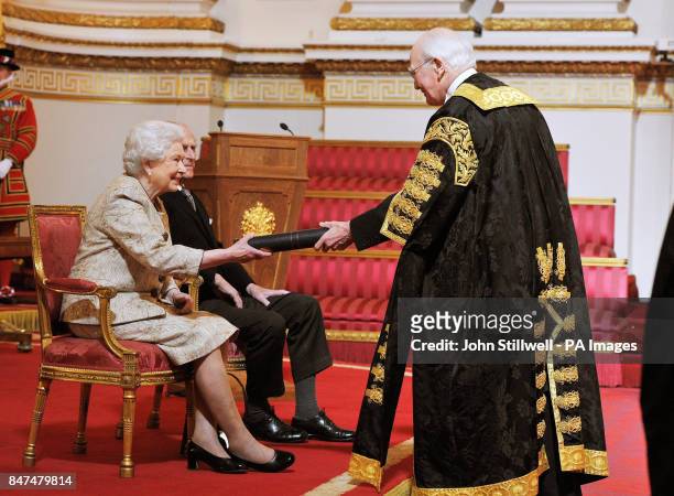Queen Elizabeth II accompanied by the Duke of Edinburgh receives a copy of the loyal address from the University of St Andrews Chancellor Sir Menzies...