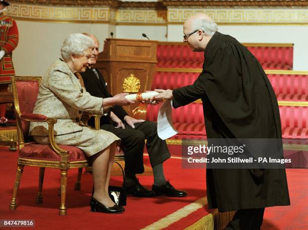 Queen Elizabeth II accompanied by the Duke of Edinburgh receives a copy of the loyal address from the Moderator of the free Churches group Rev...