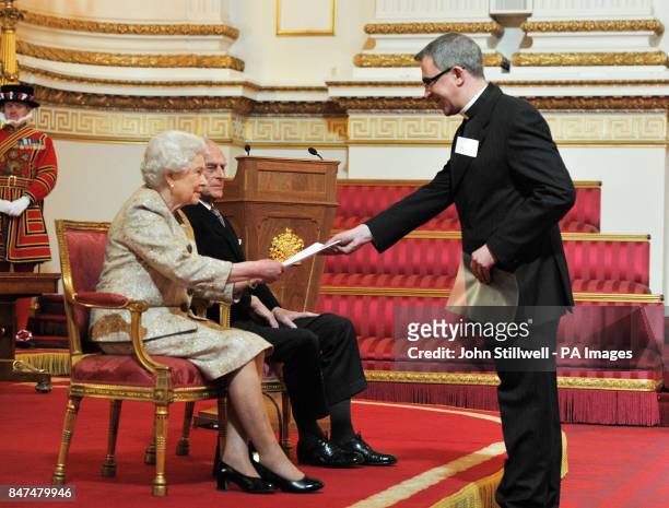 Queen Elizabeth II accompanied by the Duke of Edinburgh receives a copy of the loyal address from the Chapter of St Paul's Cathedral Canon Michael...