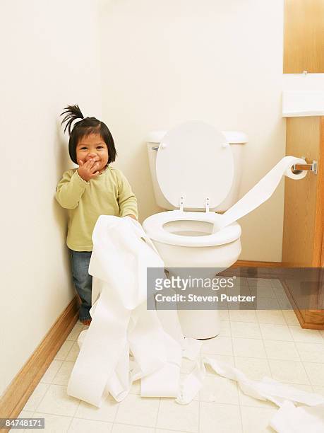 female toddler unrolling toilet paper  - sorry funny stock pictures, royalty-free photos & images